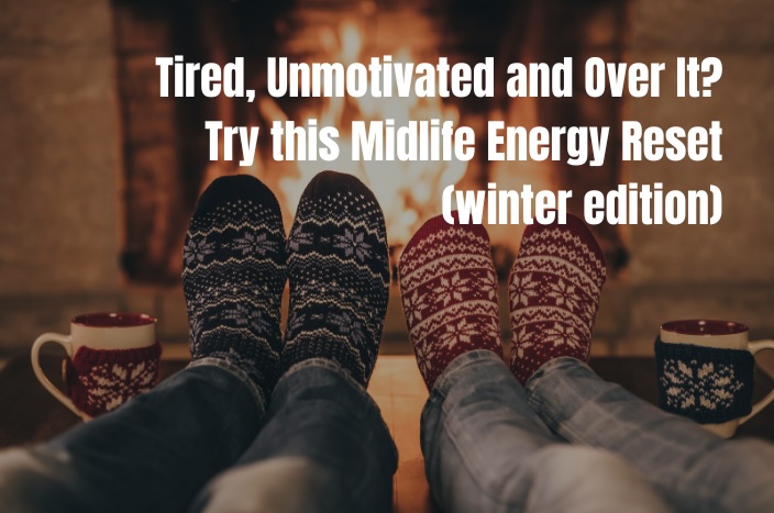 Tired All the Time Try This Midlife Energy Reset Winter Edition | best life loading 2 people sitting in front of the fire in cosy socks with mugs beside for winter bliss.