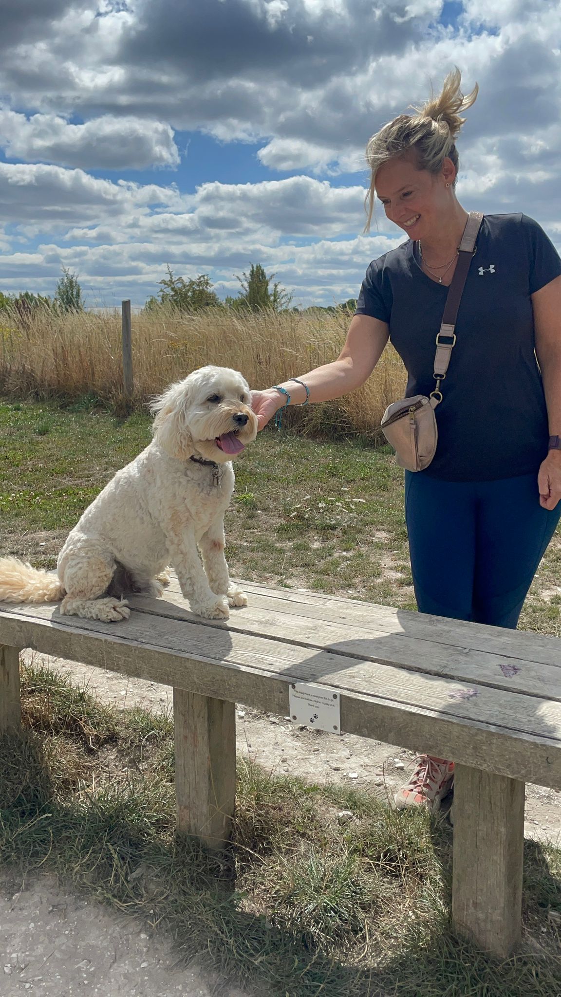 Sarah Ewen smiling with her dog Digby outdoors